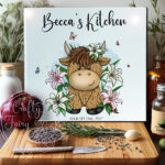 personalised highland cow with pink lily flowers glass chopping board or worktop protector