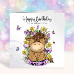 personalised highland cow with bright spring flowers birthday card