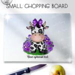 personalised friesian cow and purple flowers glass chopping board