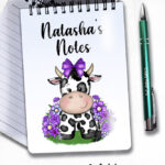 personalised friesian cow and purple flowers notebook